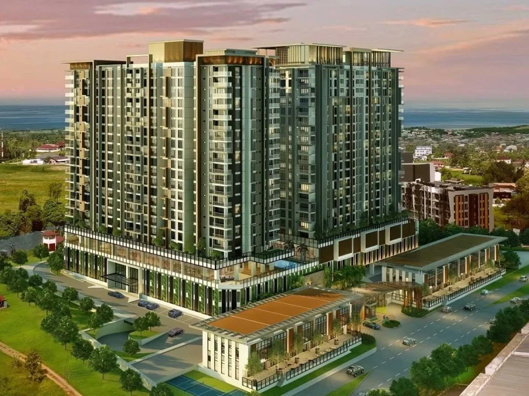 High-rise apartment complex featuring green and beige facades with commercial spaces and landscaped surroundings