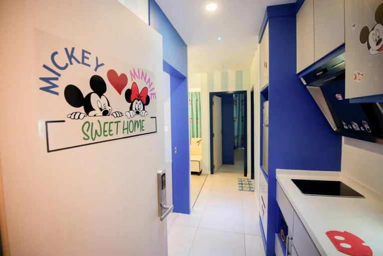 Vibrant Mickey Mouse Suites entrance featuring character artwork, contemporary blue kitchen and modern kitchen cabinetry